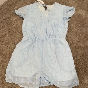 NWT Light blue polka dot romper with snap chest closure.